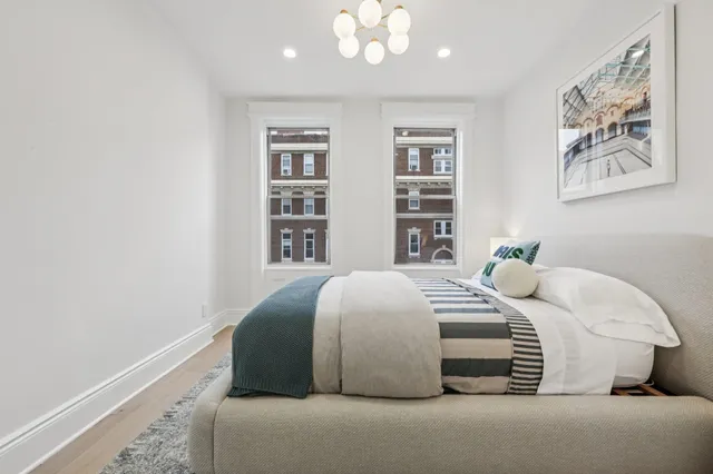 a bedroom with a bed and a lamp