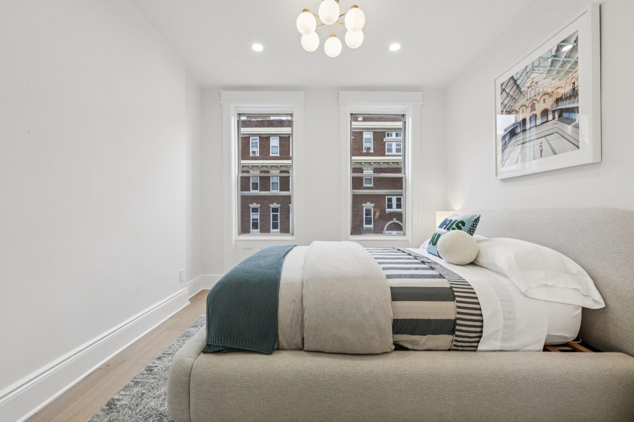 97 Clifton Terrace, Unit 6 Weehawken, NJ 07086 - Photo 21 of 36 a bedroom with a large bed and a window