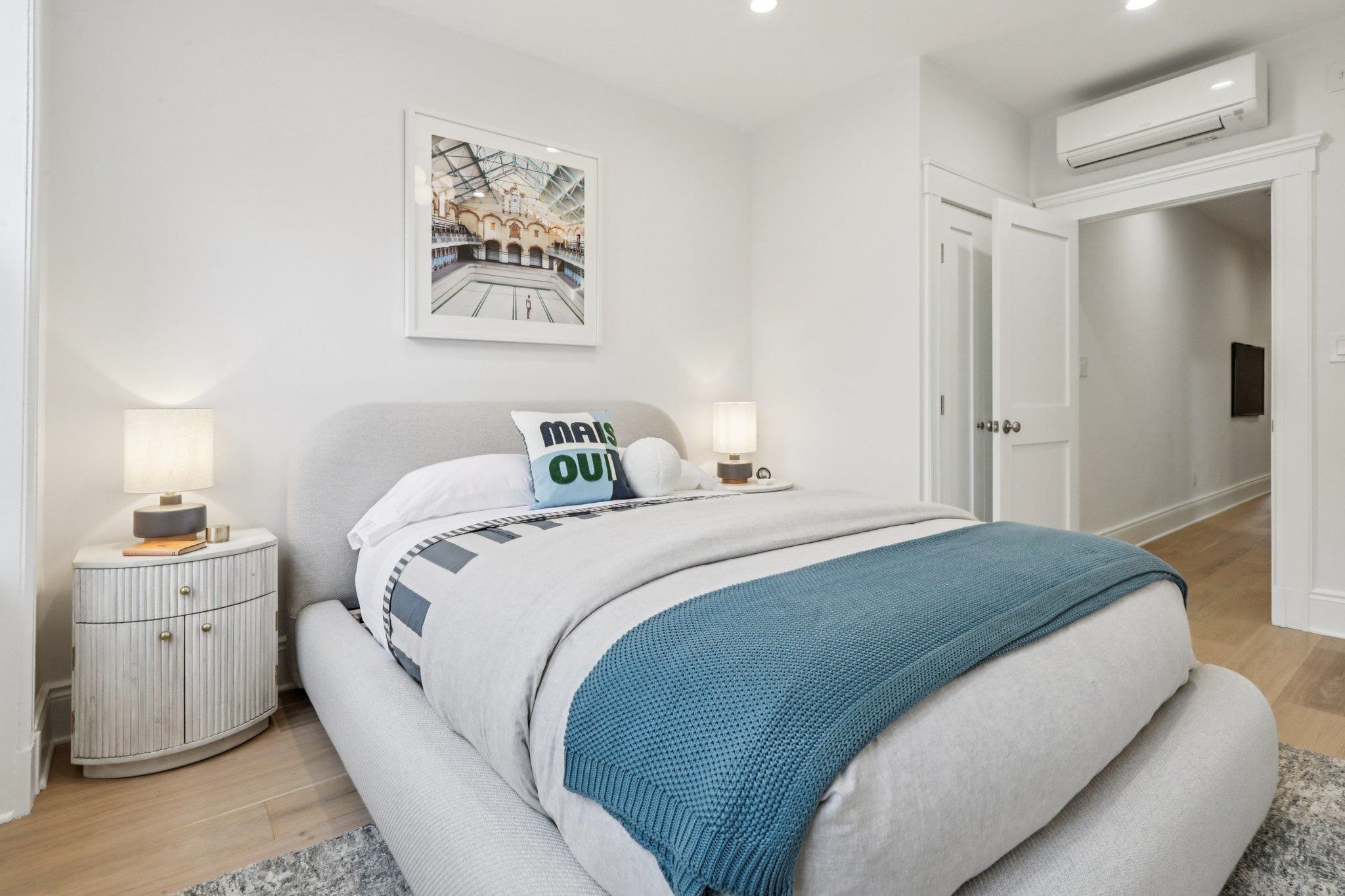 97 Clifton Terrace, Unit 6 Weehawken, NJ 07086 - Photo 22 of 36 a bedroom with a bed and a lamp