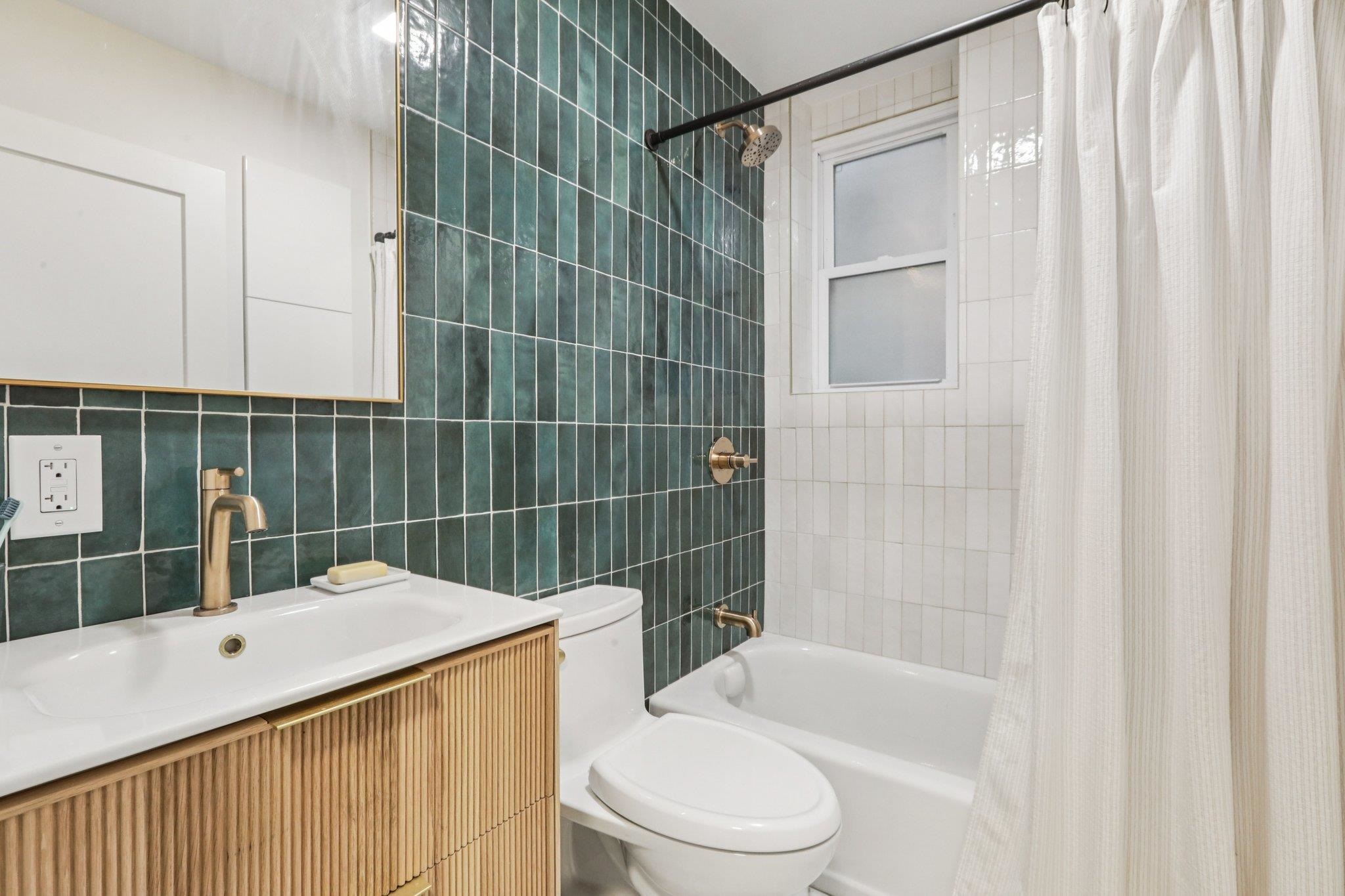 97 Clifton Terrace, Unit 6 Weehawken, NJ 07086 - Photo 24 of 36 a bathroom with a sink toilet and shower