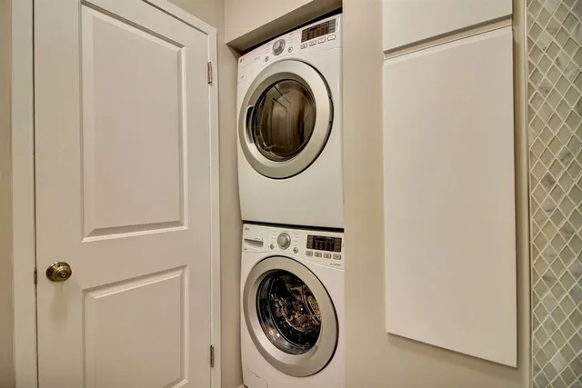 a view of a hallway with wooden floor and closet