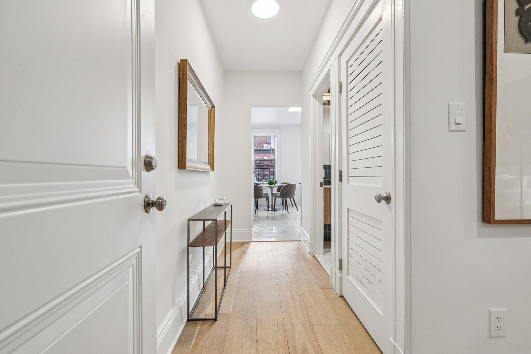 97 Clifton Terrace, Unit 6 Weehawken, NJ 07086 - Photo 9 of 36 a view of a hallway with wooden floor and staircase