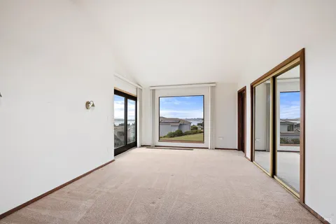 a view of a room with a large window and front door