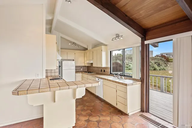 a open kitchen with a sink stove and cabinets