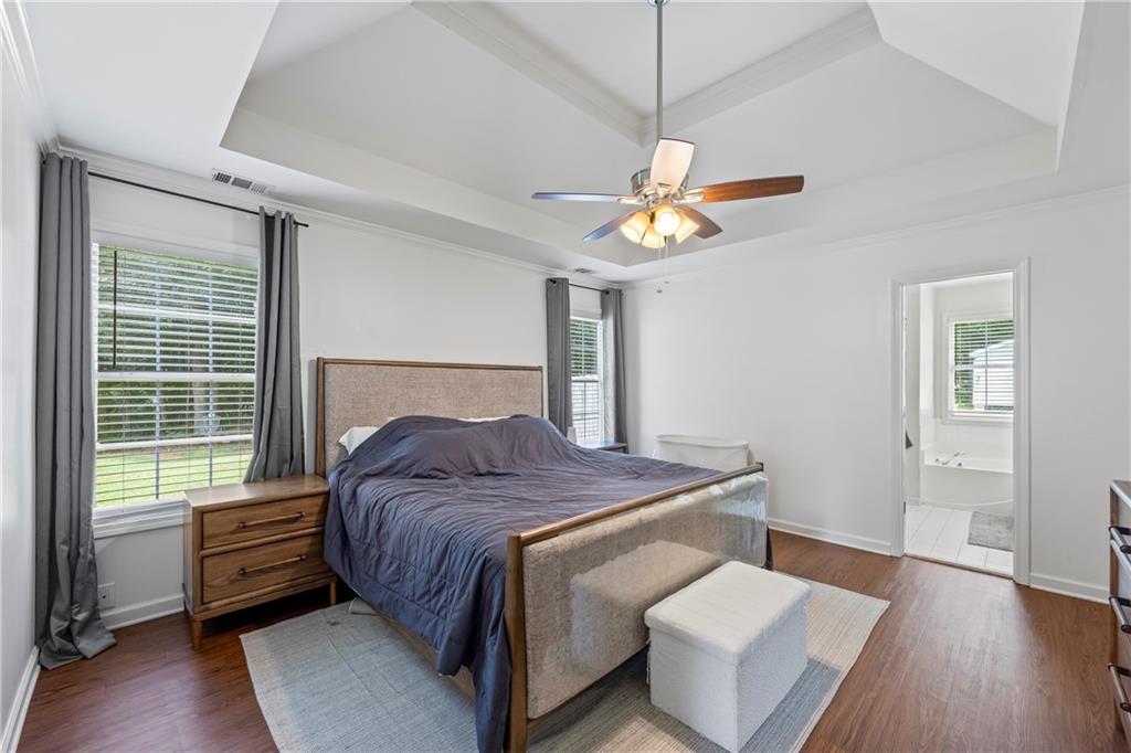 2630 Track Way Dacula, GA 30019 - Photo 19 of 27 a bedroom with a bed and a chandelier