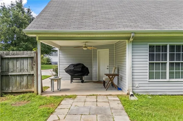 a view of house with outdoor seating area and a garden