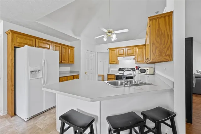 a kitchen with a sink cabinets and refrigerator