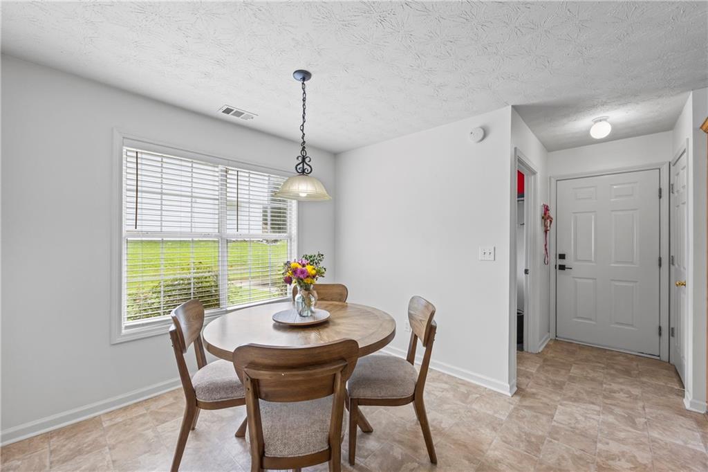 2630 Track Way Dacula, GA 30019 - Photo 8 of 27 a view of a dining room with furniture window and outside view