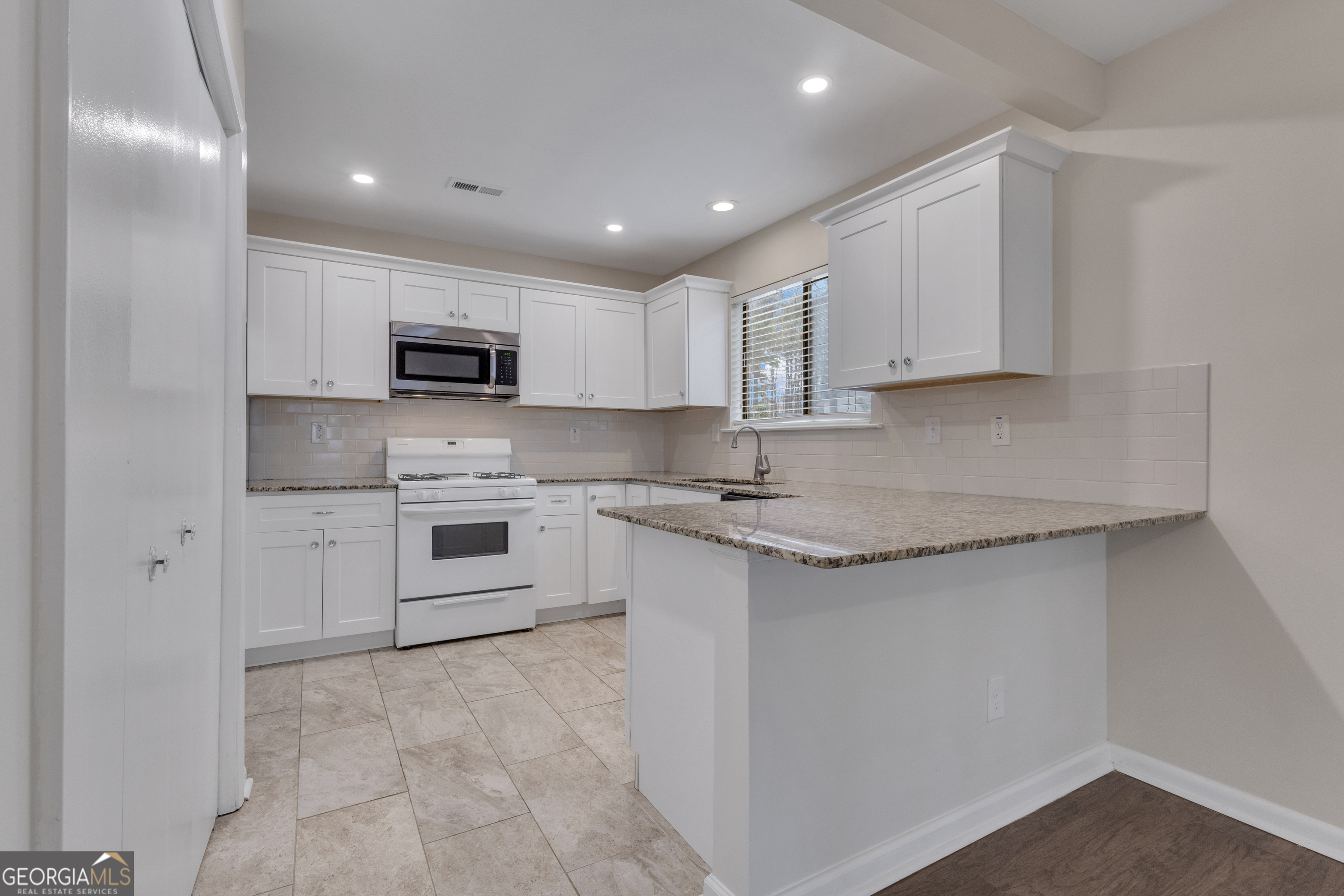 101 Dove Rise Peachtree City, GA 30269 - Photo 11 of 41 a kitchen with kitchen island a white counter top space cabinets and stainless steel appliances