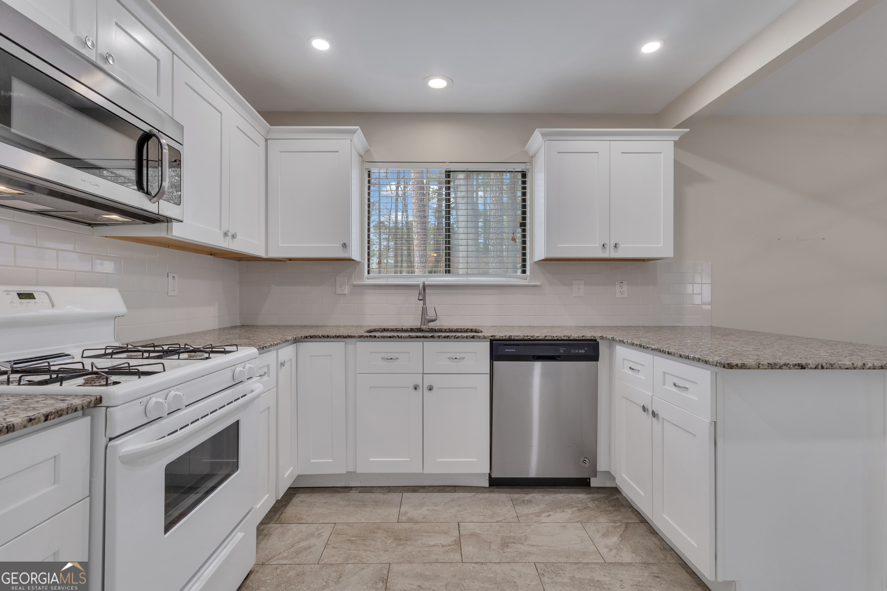 101 Dove Rise Peachtree City, GA 30269 - Photo 15 of 41 a kitchen with stainless steel appliances granite countertop a stove and a sink