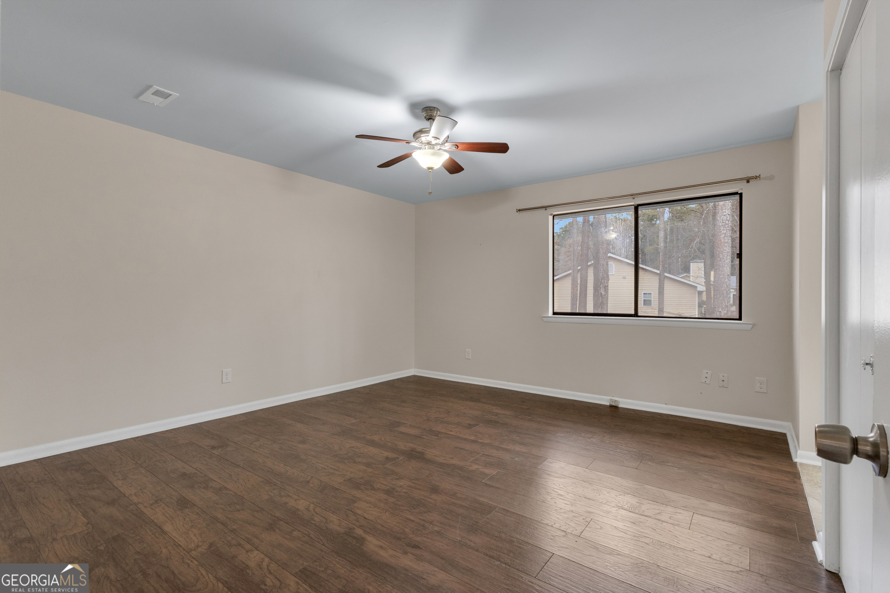 101 Dove Rise Peachtree City, GA 30269 - Photo 18 of 41 an empty room with wooden floor ceiling fan and windows