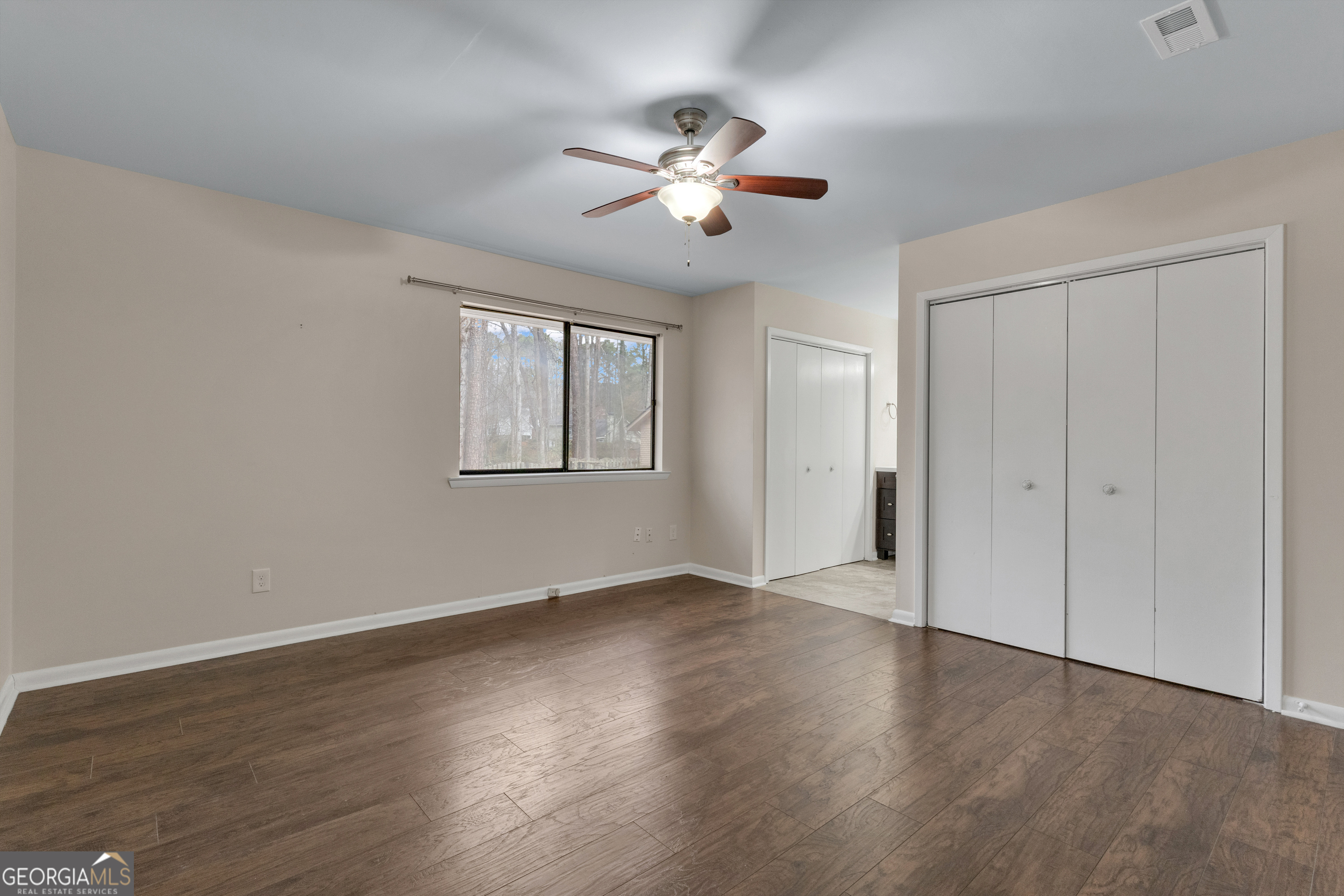 101 Dove Rise Peachtree City, GA 30269 - Photo 19 of 41 a view of an empty room with wooden floor and a ceiling fan
