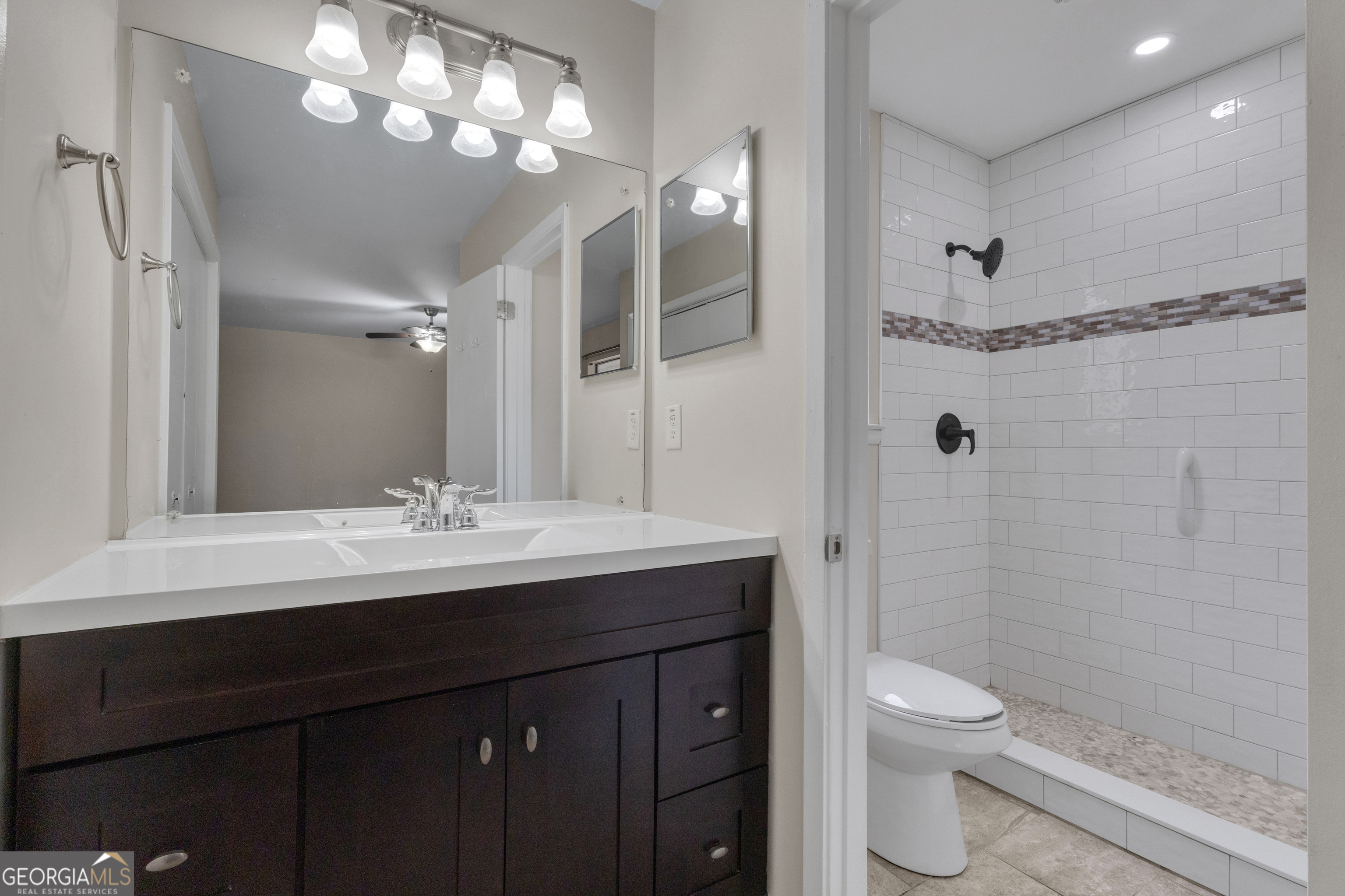 101 Dove Rise Peachtree City, GA 30269 - Photo 23 of 41 a bathroom with a sink a toilet a mirror and shower