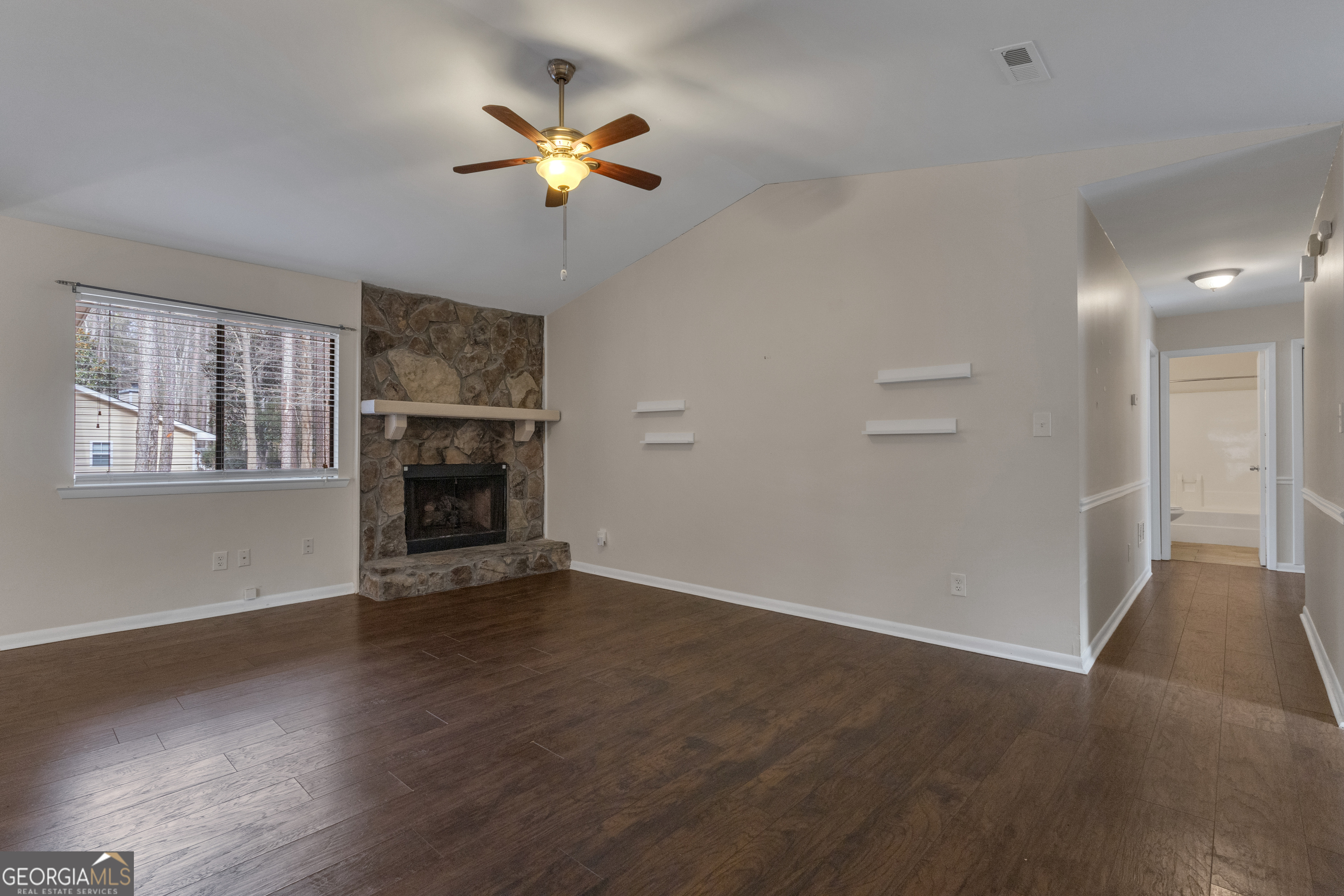 101 Dove Rise Peachtree City, GA 30269 - Photo 5 of 41 an empty room with wooden floor fireplace and windows
