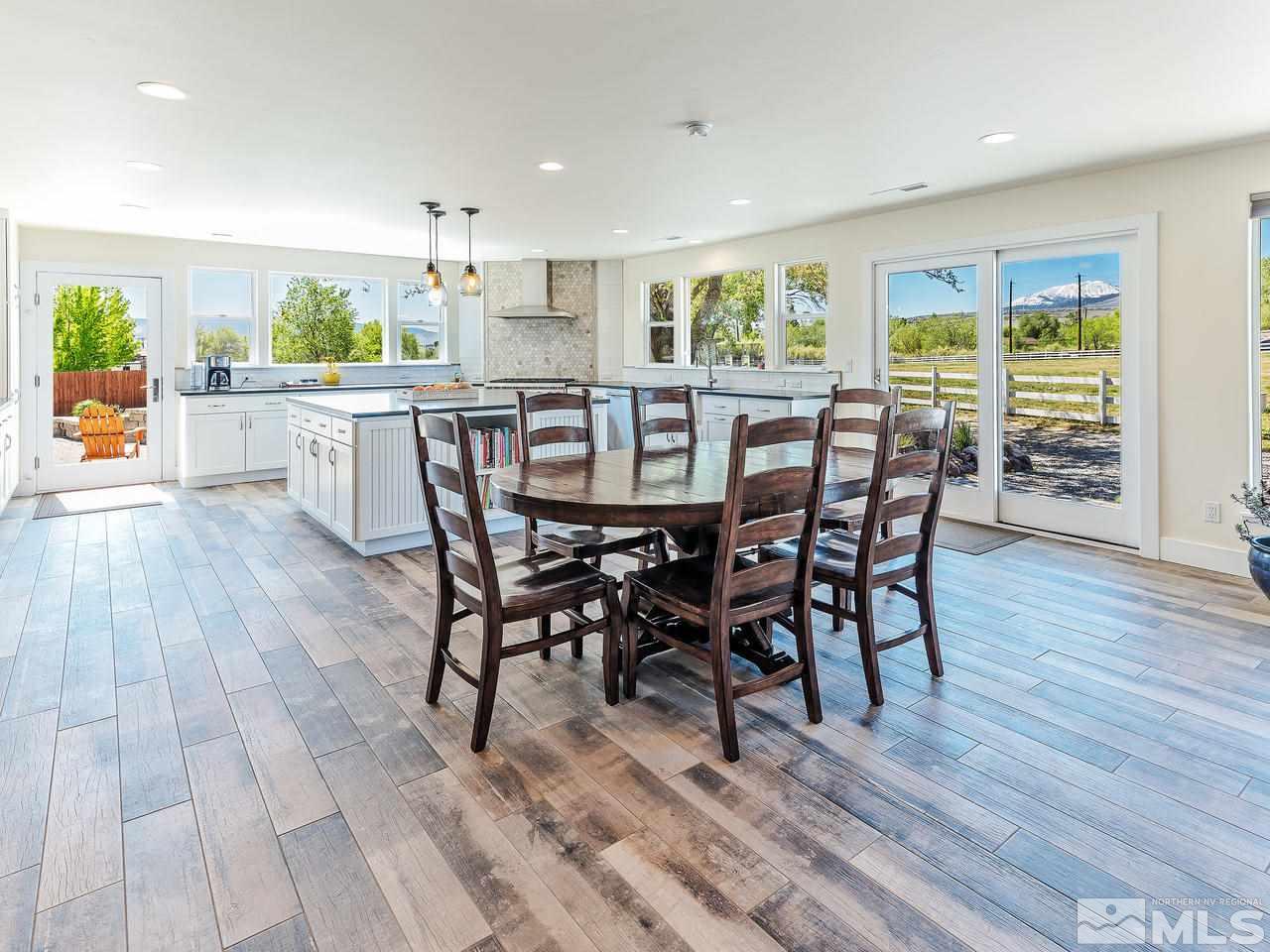 1700 Davis Lane Reno, NV 89511 - Photo 4 of 25 a kitchen with stainless steel appliances a dining table chairs and wooden floor