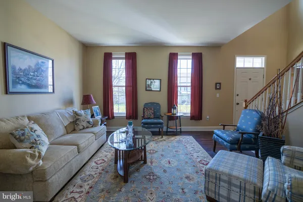 a living room with furniture and a dining table