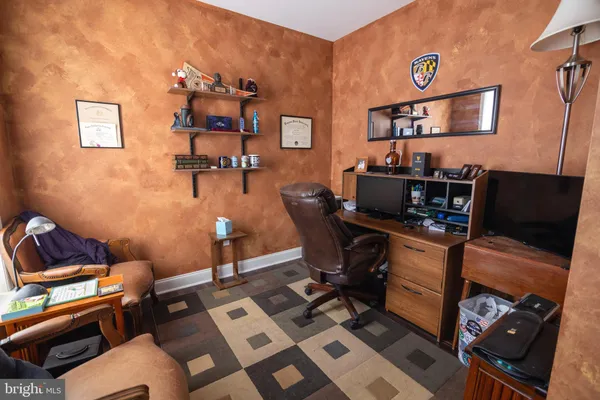 a bedroom with a bed and a mirror on dresser
