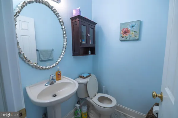 a bedroom with a bed a mirror and a window