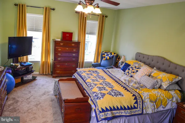 a bedroom with a bed and a mirror