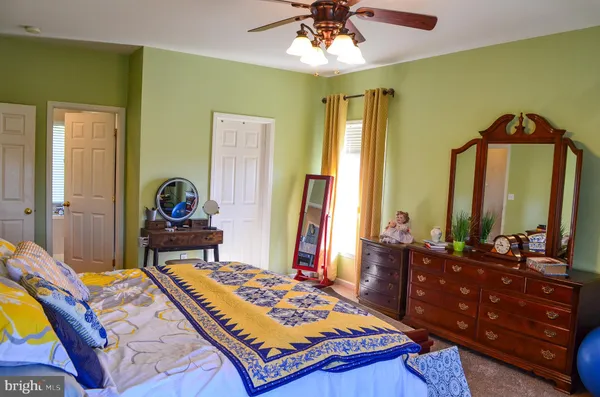 a bedroom with a bed and a computer on a table