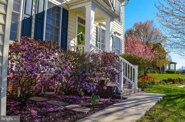 a front view of a house with a garden and porch
