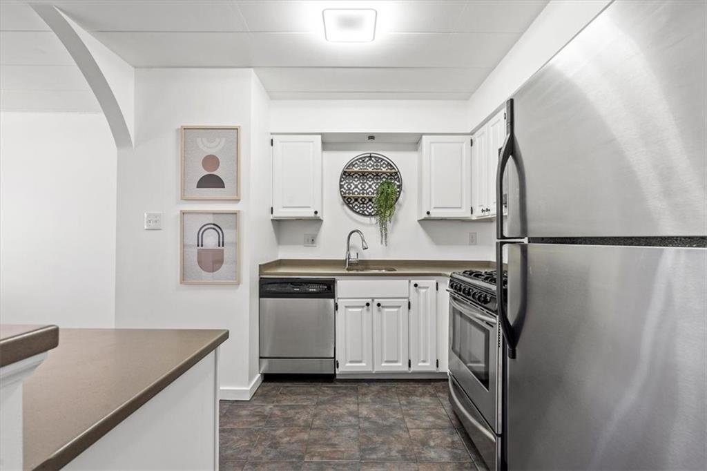 5 Bayard Road, Unit 911 Pittsburgh, PA 15213 - Photo 8 of 21 a kitchen with stainless steel appliances granite countertop a sink stove and refrigerator