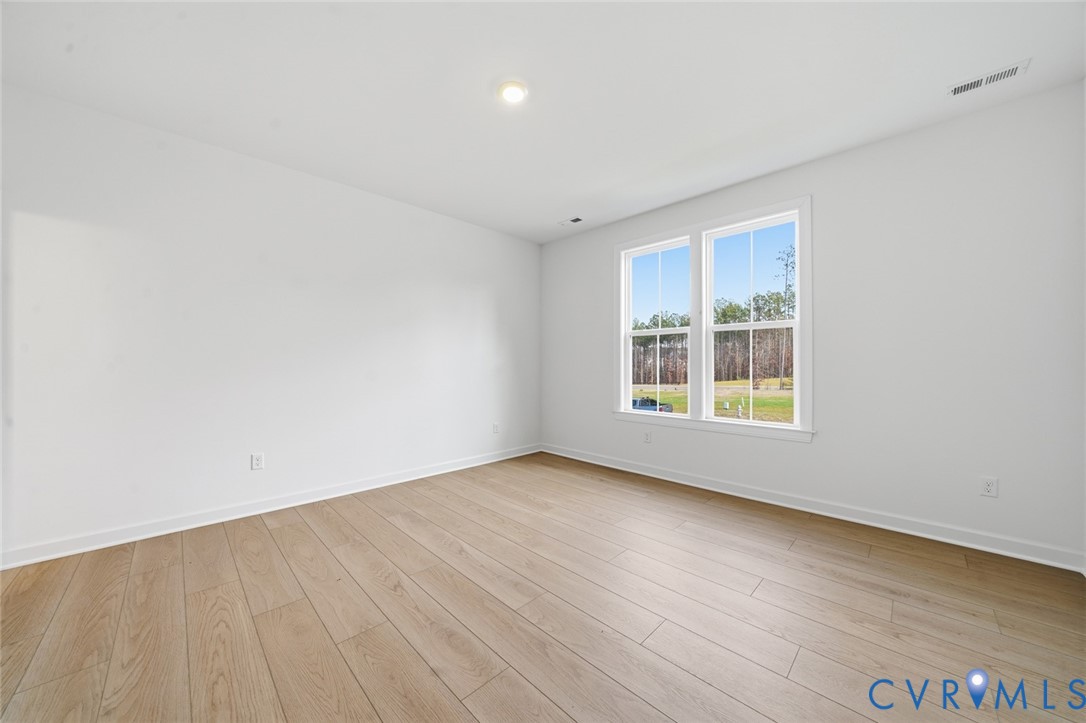 19025 Palisades Ridge Moseley, VA 23120 - Photo 15 of 41 an empty room with wooden floor and windows