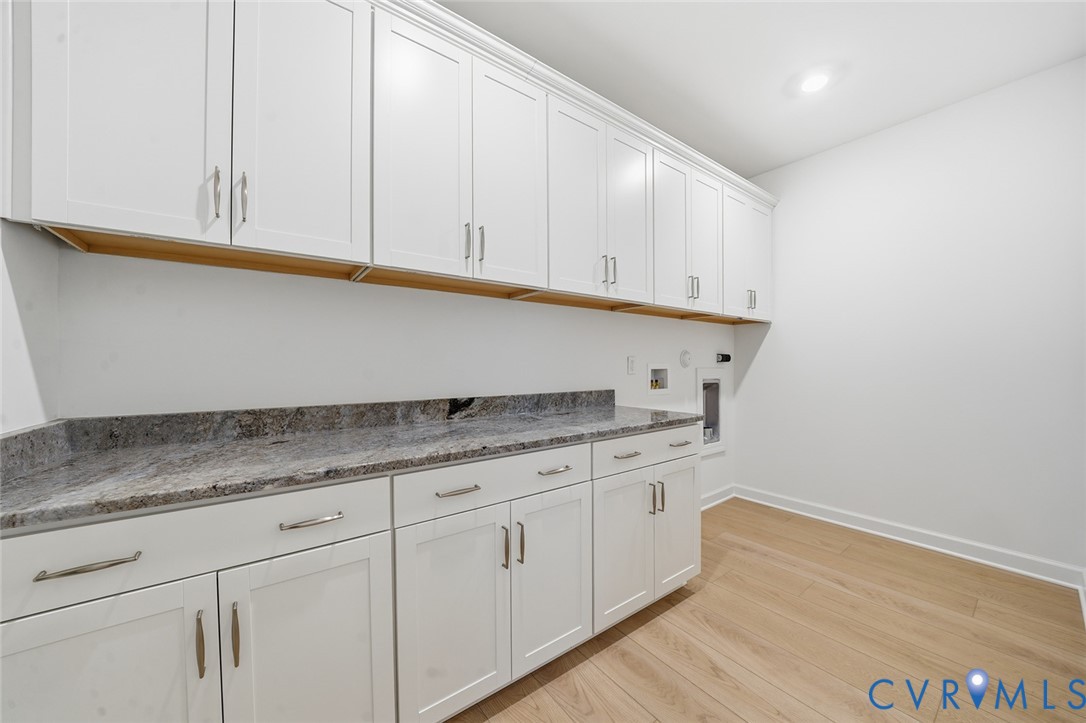 19025 Palisades Ridge Moseley, VA 23120 - Photo 19 of 41 a kitchen with granite countertop white cabinets and a wooden floor