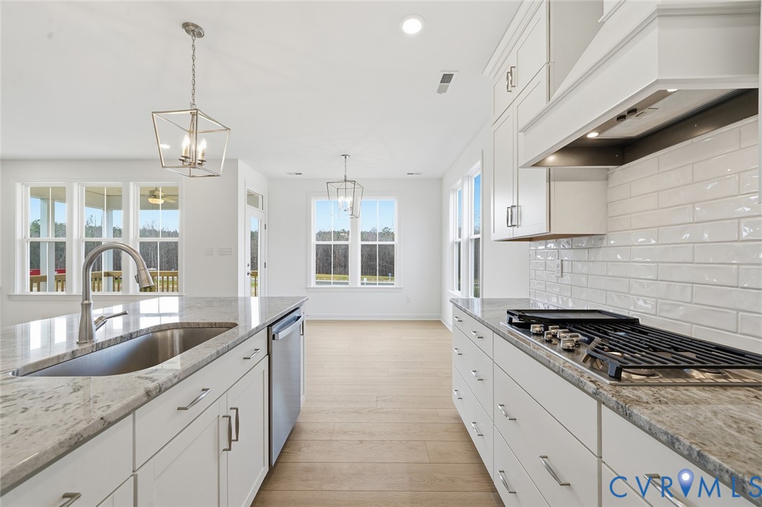 19025 Palisades Ridge Moseley, VA 23120 - Photo 3 of 41 a kitchen with granite countertop a stove and a sink