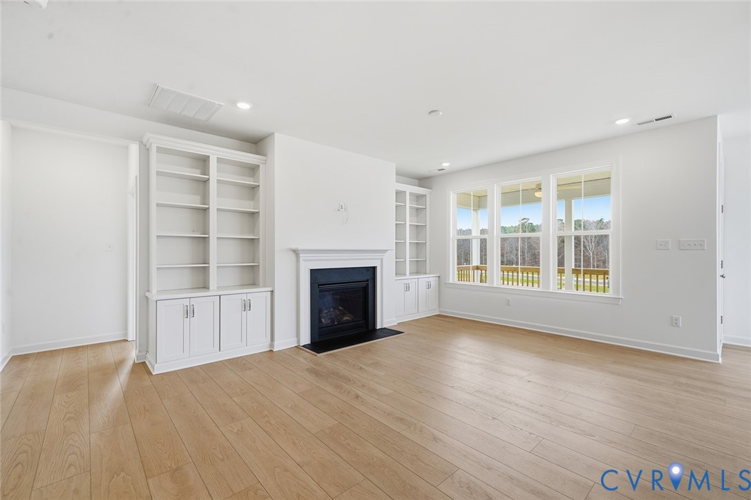 19025 Palisades Ridge Moseley, VA 23120 - Photo 8 of 41 a view of an empty room with a fireplace and a window