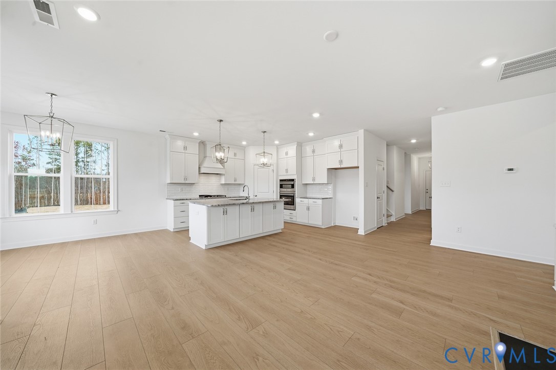 19025 Palisades Ridge Moseley, VA 23120 - Photo 9 of 41 a view of kitchen with wooden floor and windows