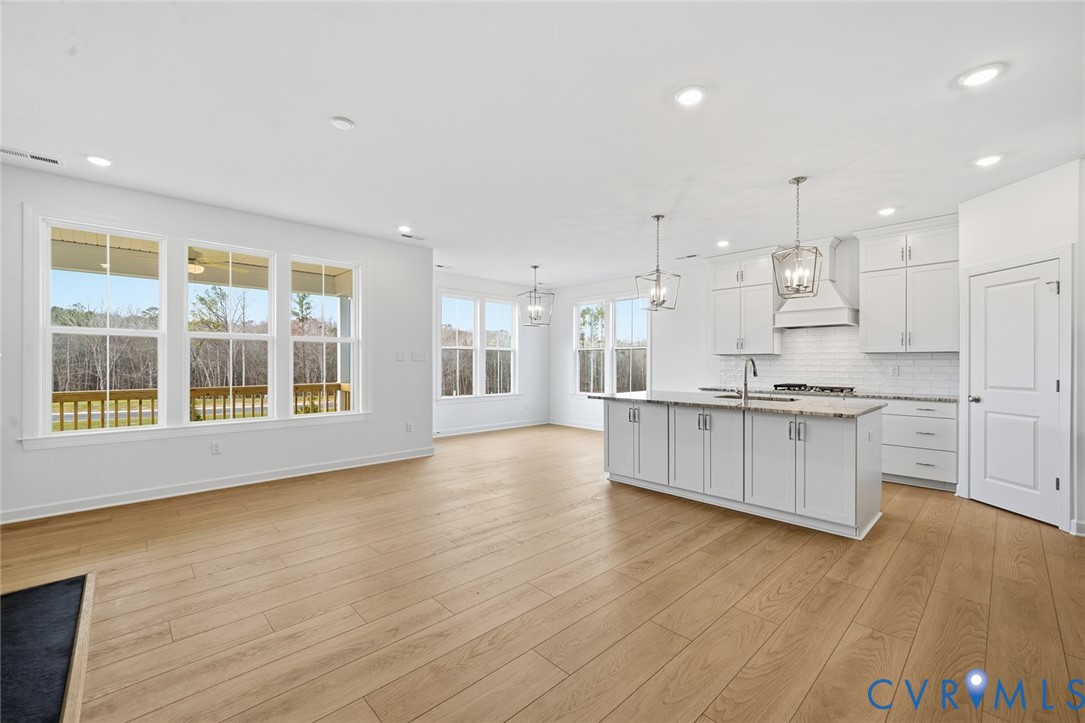 19025 Palisades Ridge Moseley, VA 23120 - Photo 10 of 41 a large kitchen with stainless steel appliances granite countertop a large counter top a stove and a wooden floors