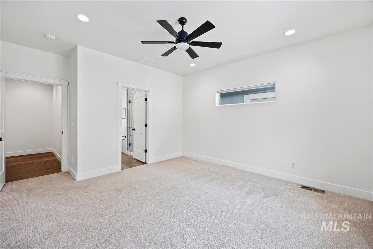 924 Trapper Peak Road Kimberly, ID 83341 - Photo 19 of 40 Unfurnished bedroom with light carpet, recessed lighting, and ceiling fan