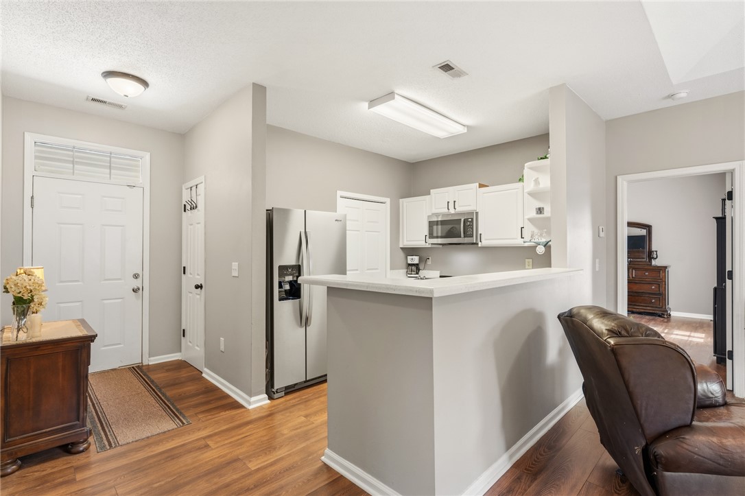 160 Wexford Drive, Unit 206 Anderson, SC 29621 - Photo 6 of 31 Enter into a wide foyer with hall closet. The unit features LVP flooring and a modern kitchen with a breakfast bar.