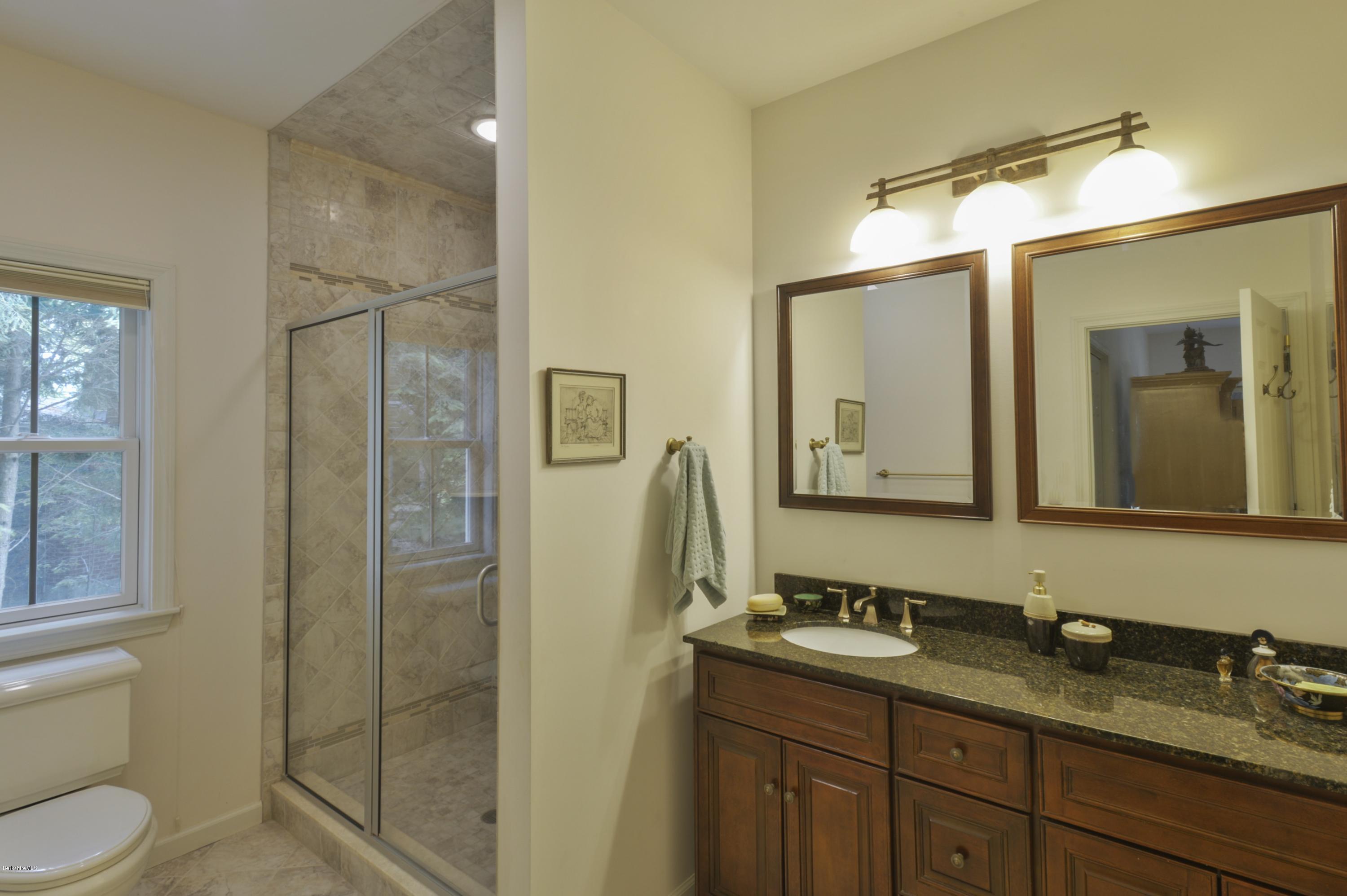 24 Point Road Monterey, MA 01245 - Photo 11 of 17 a bathroom with a granite countertop sink toilet and shower