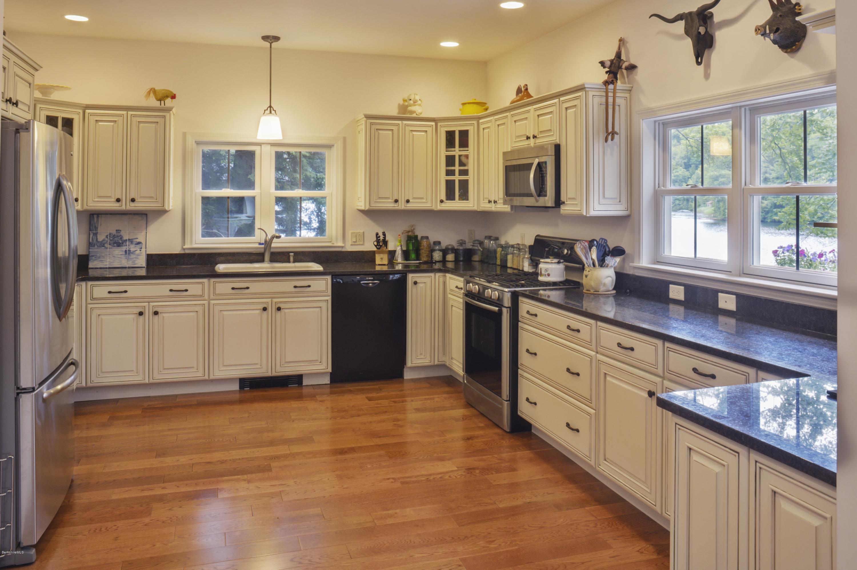 24 Point Road Monterey, MA 01245 - Photo 5 of 17 a large kitchen with granite countertop a stove top oven a sink a window and cabinets