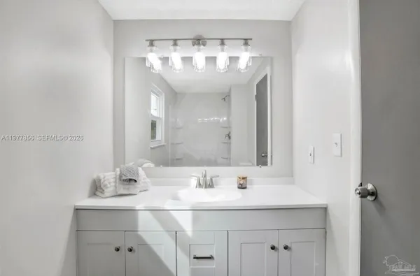 a bathroom with a sink double vanity and a mirror
