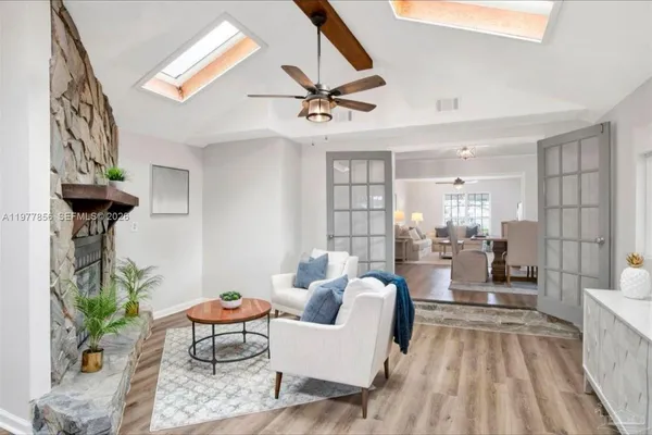 a living room with furniture and a chandelier