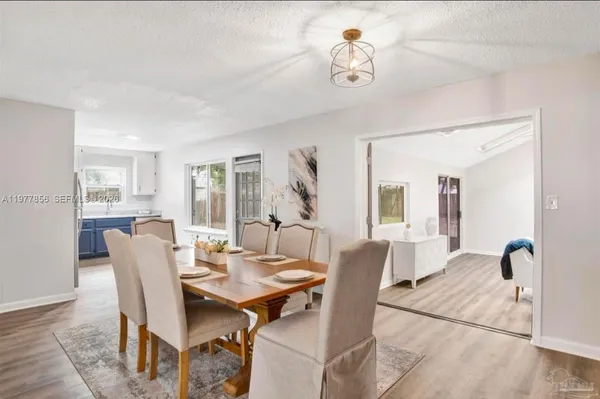 a view of a dining room with furniture and chandelier