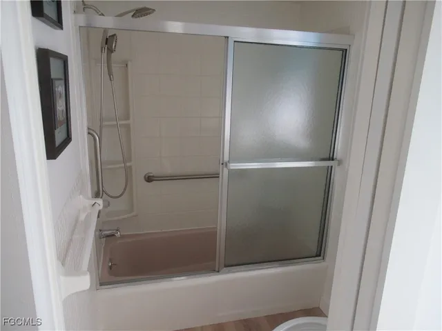 a bathroom with a glass shower door
