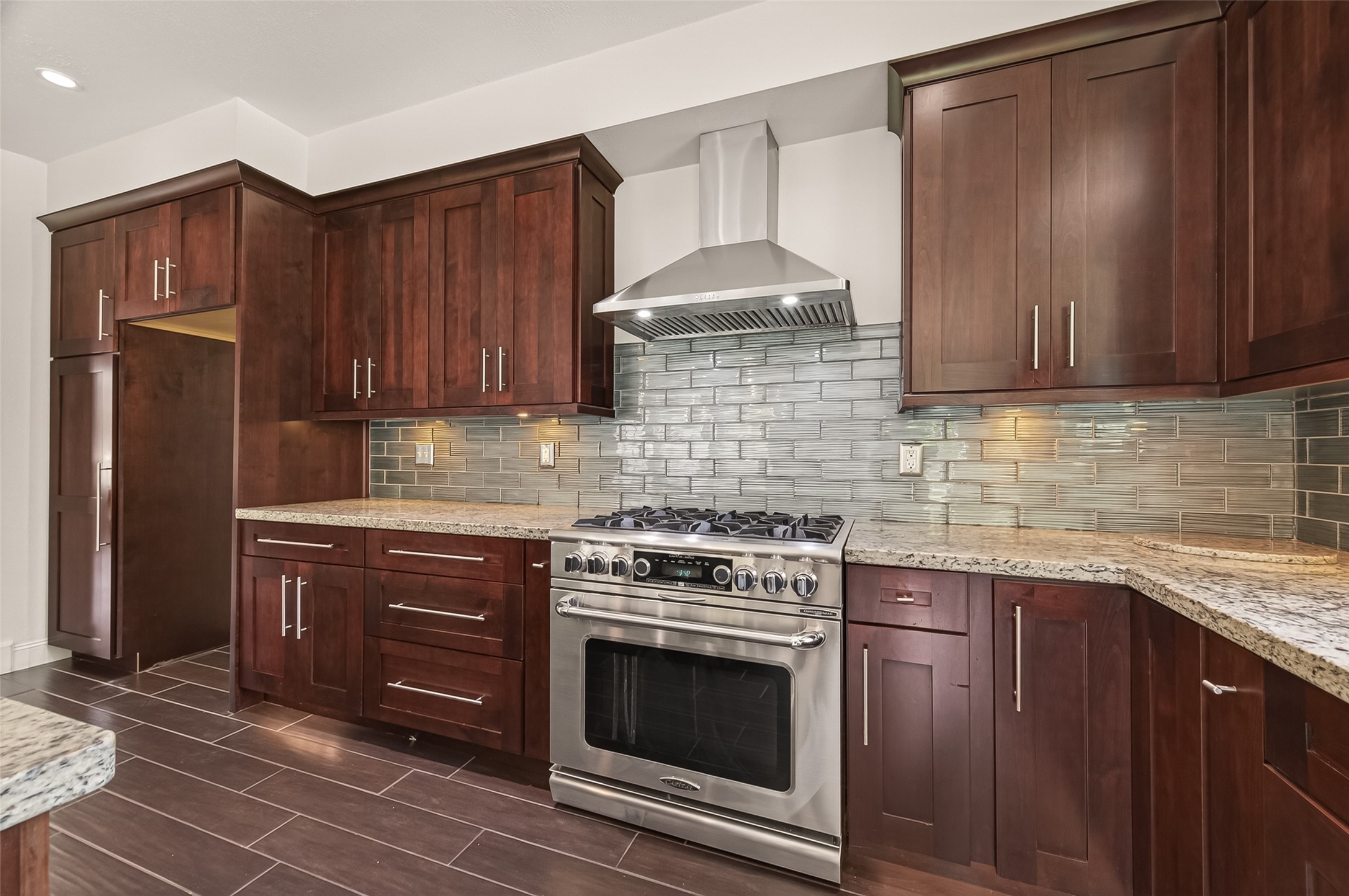6131 Hampton Way Court Spring, TX 77389 - Photo 19 of 50 a kitchen with granite countertop wooden cabinets and stainless steel appliances