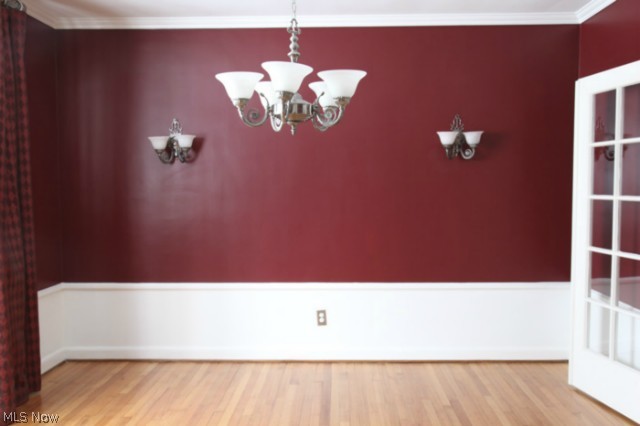 3712 Traynham Road Beachwood, OH 44122 - Photo 7 of 25 The formal dining room features gleaming wood floors, replacement lighting: sconces & chandelier, bayed window, French doors into living room, chair railing & radiator w/cover.