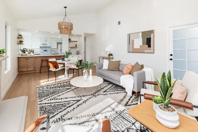 a living room with furniture kitchen view and a dining table