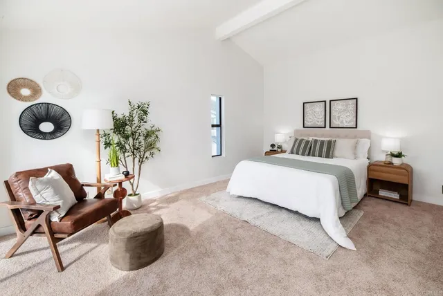 a bedroom with a bed and a chair