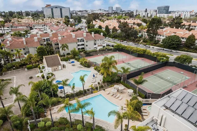an aerial view of a house with a garden and lake view