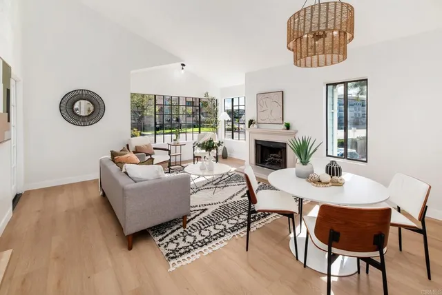 a living room with furniture a fireplace and a table