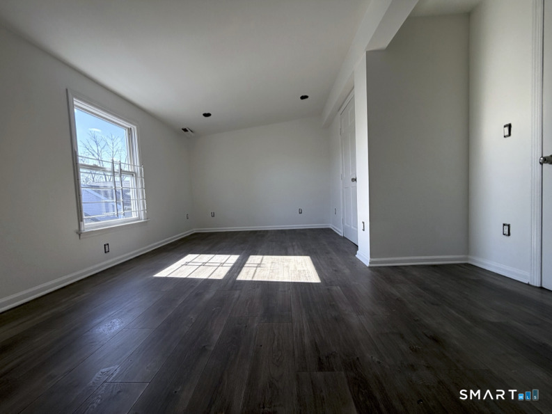 30 Dora Street Stamford, CT 06902 - Photo 15 of 18 an empty room with wooden floor and windows