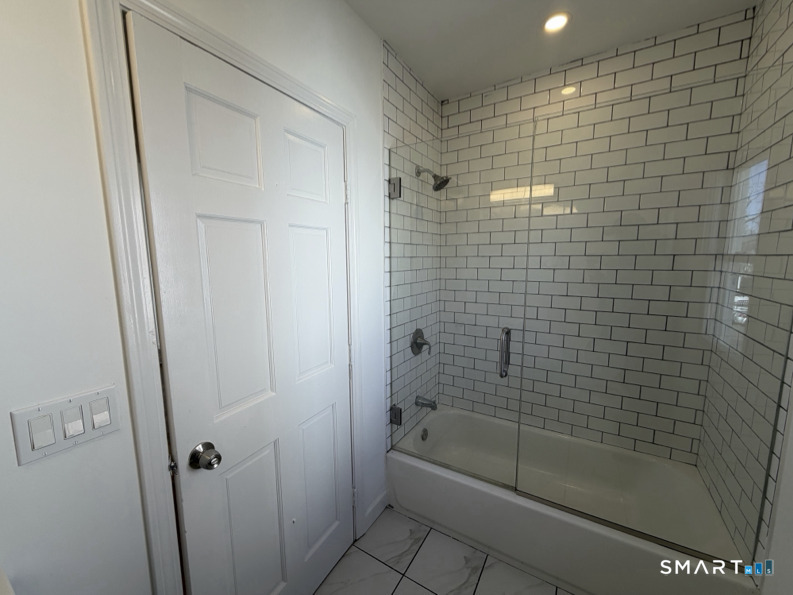 30 Dora Street Stamford, CT 06902 - Photo 8 of 18 a bathroom with a shower and a bathtub