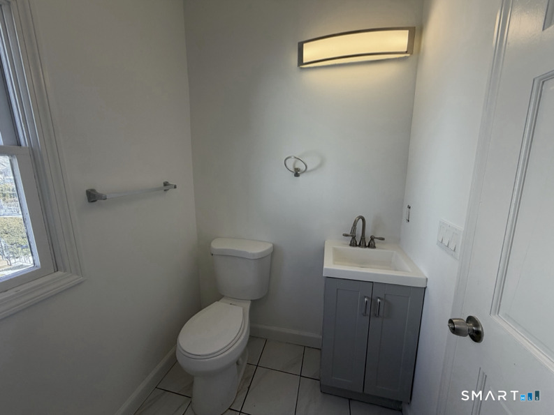 30 Dora Street Stamford, CT 06902 - Photo 9 of 18 a bathroom with a toilet sink and mirror