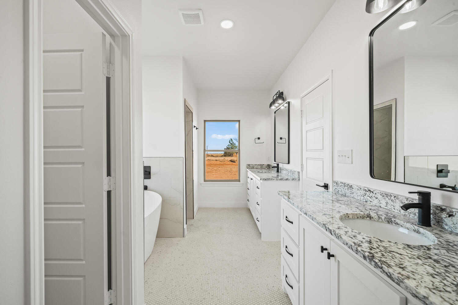4062 Hawk Road Ropesville, TX 79358 - Photo 14 of 45 a spacious bathroom with a granite countertop sink mirror and a